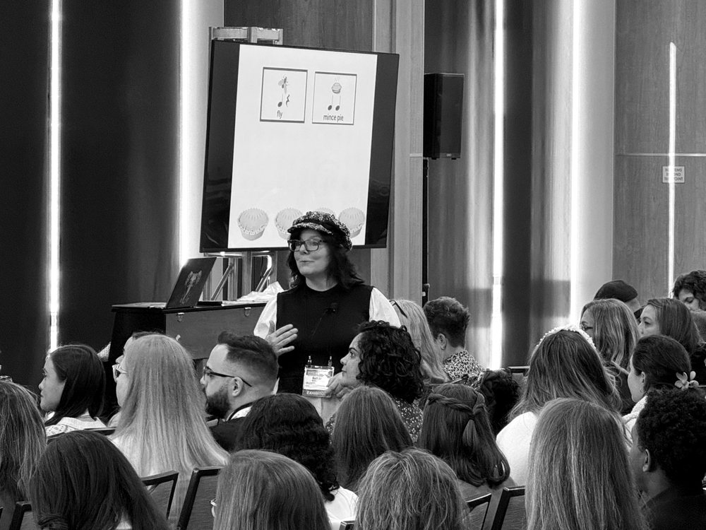 A presenter leading a music education session for teachers